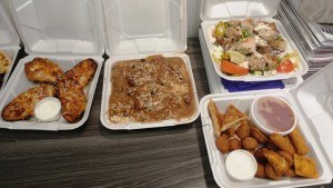 Loaded 'Skins, Chicken Marsala, Greek Salad, and appetizer plate.